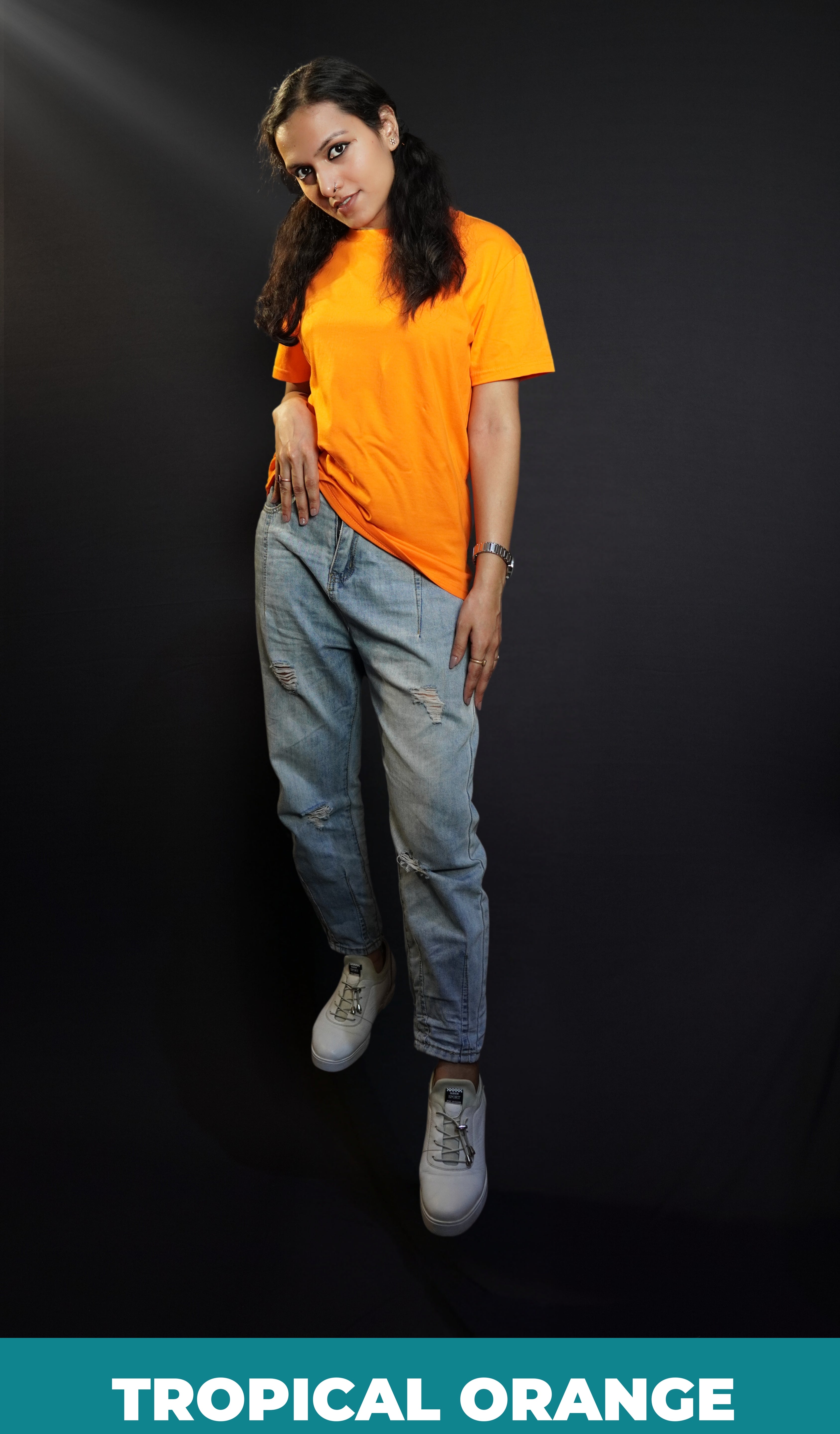 A woman wearing a small size round neck quick drying short sleeved t-shirt, posing with her hand on her waist and head bent down a little, showcasing a up to the minute casual fit-Muselot