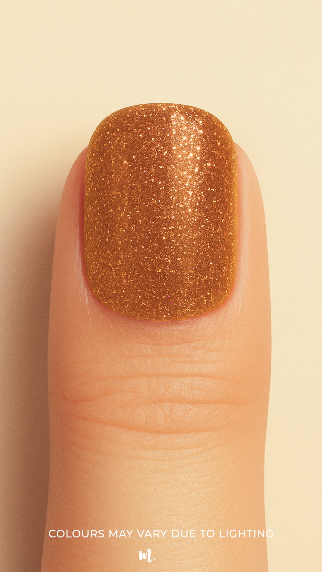 A close-up shot of a model’s finger wearing Warm Gold Glitter nail stickies, showcasing the dazzling golden shade packed with fine glitter particles, highlighting the sparkle and glam of solid glitter nail art with a smooth, glossy finish – Muselot.