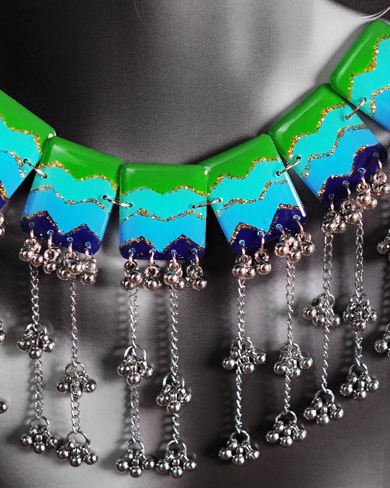 A close-up shot of a woman wearing the waterfall boho jewelry set, focusing on the layered arrangement and elements and cascading beads gracefully resting on her neckline, showcasing the artisanal detail and vibrant charm of this statement piece — Muselot.
