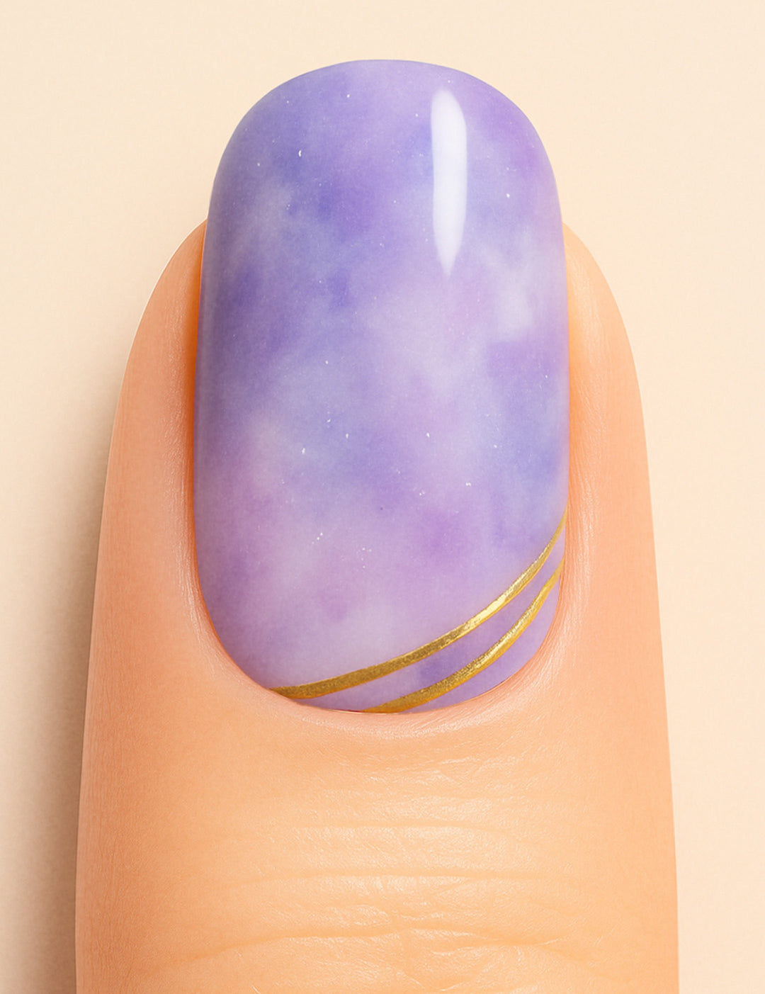 A close-up shot of a model’s finger featuring Wavy Dream Marble Nail Stickies, designed with a dreamy purple marble effect accented by fine white patterns and elegant golden wave lines near the tip, giving a soft yet luxurious finish to the nail art-Muselot
