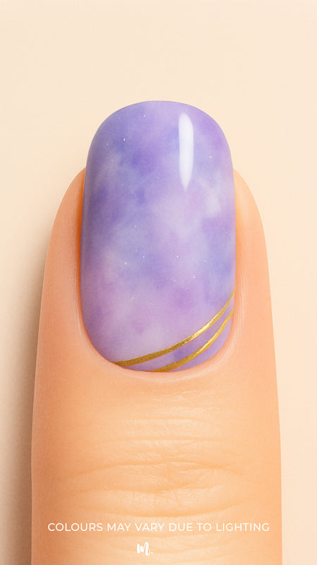 A close-up shot of a model’s finger featuring Wavy Dream Marble Nail Stickies, designed with a dreamy purple marble effect accented by fine white patterns and elegant golden wave lines near the tip, giving a soft yet luxurious finish to the nail art-Muselot