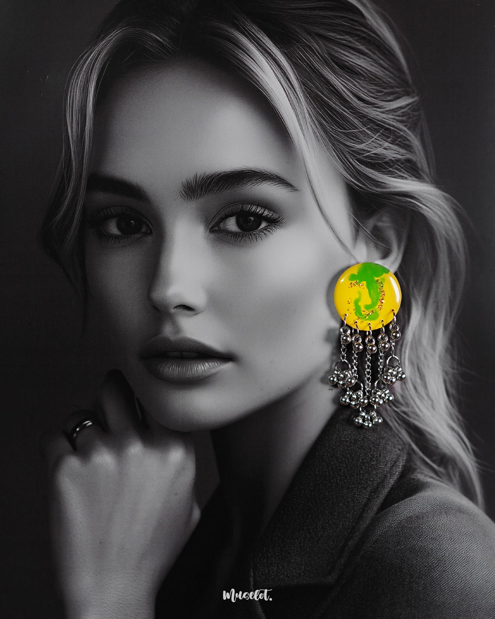 A woman wears the Zarangi handmade drop chain earrings, featuring a vivid yellow and green circular top with dangling silver chains and ghungroos, showcasing their bold fusion of tradition and modern drama — Muselot.