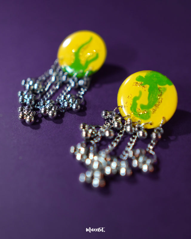 A zoomed-in view of Zarangi yellow drop earrings showing intricate floral design and layered silver chains, showcasing the handcrafted charm and boho elegance — Muselot.