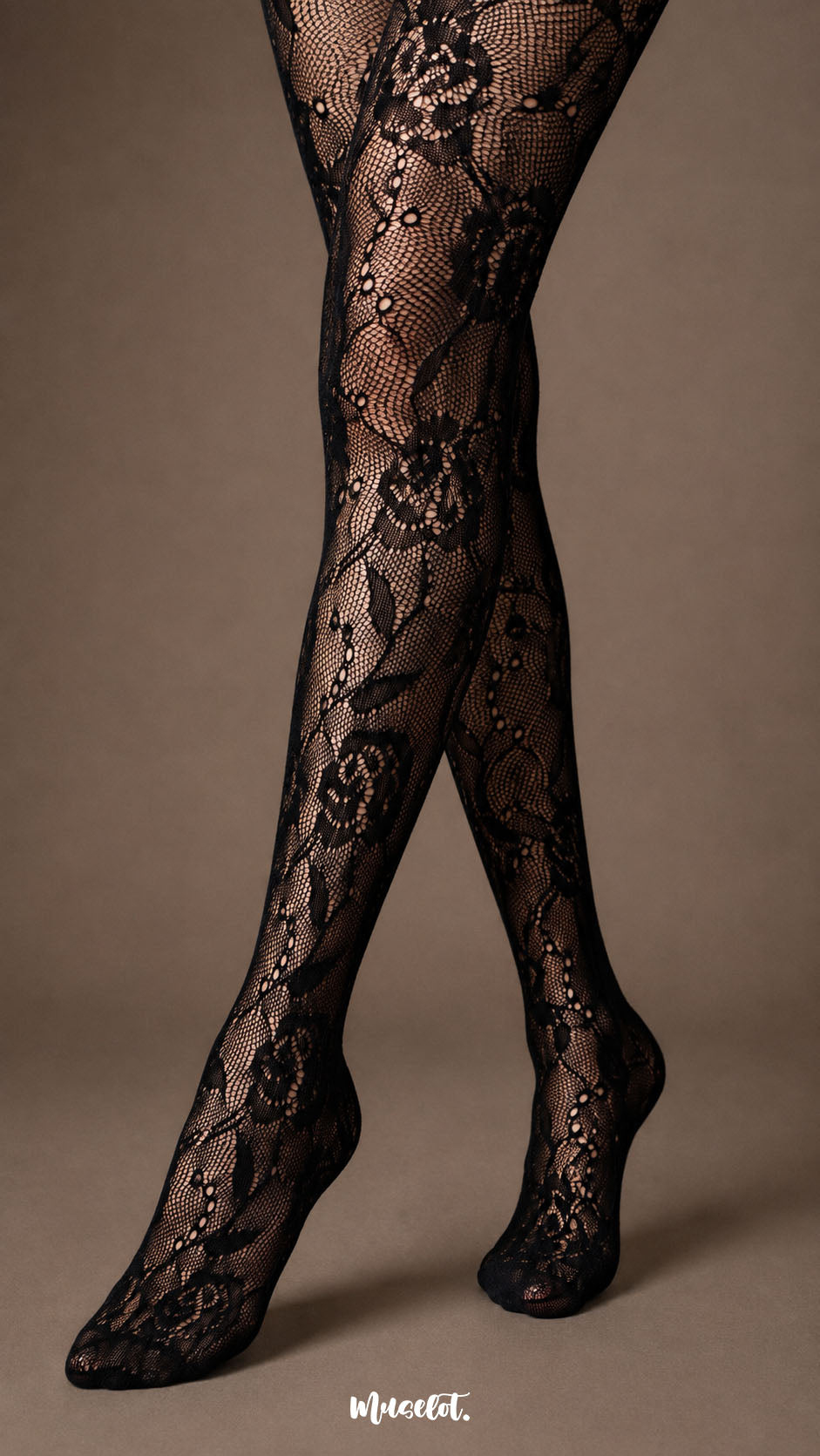 Close-up of black rose lace pantyhose over the lower legs and feet, showing fine fishnet mesh, floral motifs and closed-toe construction-Muselot