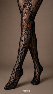 Close-up of black rose lace pantyhose over the lower legs and feet, showing fine fishnet mesh, floral motifs and closed-toe construction-Muselot
