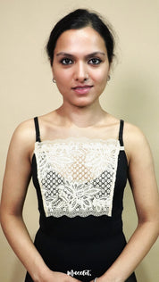front view of woman holding beige lace camisole insert to show width and shape on beige background, showcasing lace mock camisole coverage for deep neckline tops – muselot