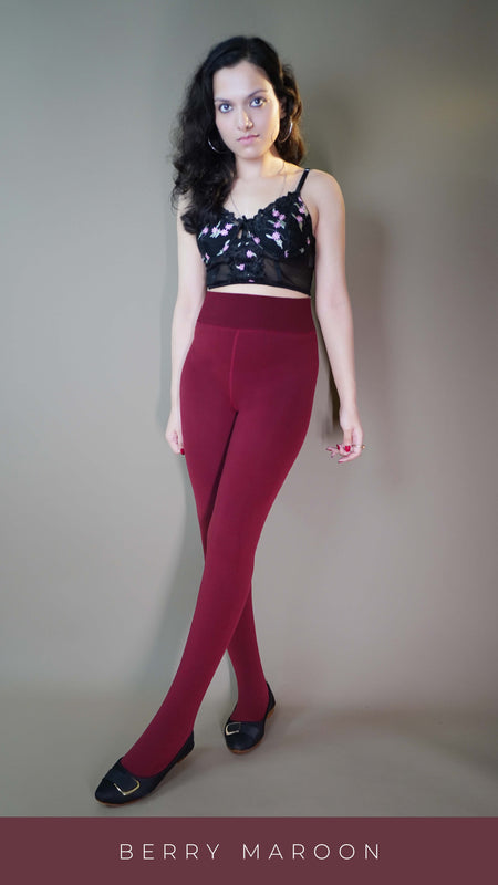A model, wearing closed-feet berry maroon warm stockings, is highlighting their luxurious, soft texture and snug fit. The deep berry color stands out, adding warmth and style, while the closed-feet design provides full coverage for extra comfort. -Muselot