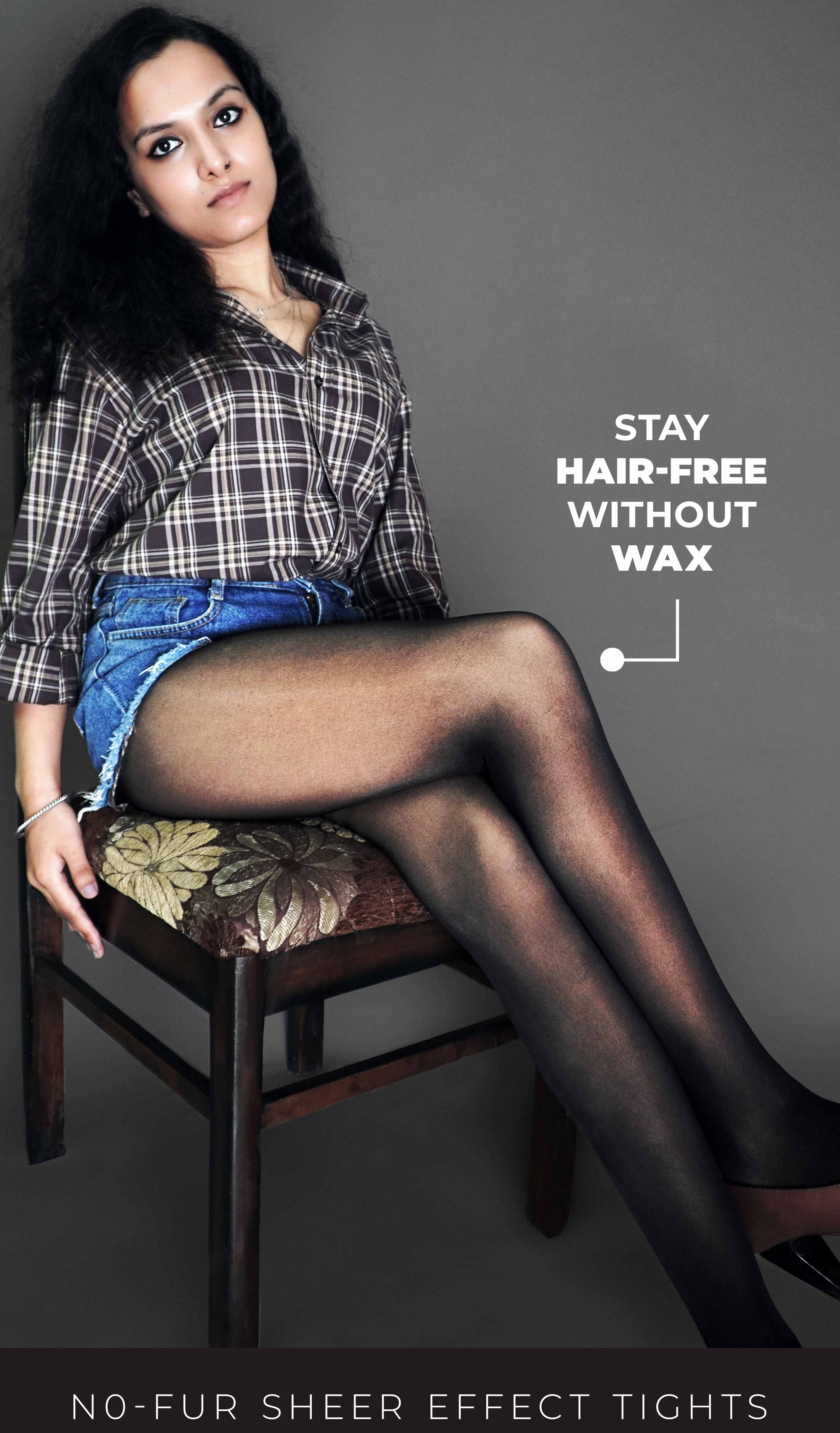 A woman wearing anti scratch sheer black stockings, posing confidently as she sits on a chair against a dark background, highlighting the transparent smooth texture of her stockings-Muselot