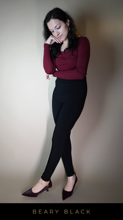 A model, wearing cozy open-feet black warm tights, showcasing their snug fit and open-foot design that adds a touch of versatility. The black color highlights a sleek, stylish look-Muselot