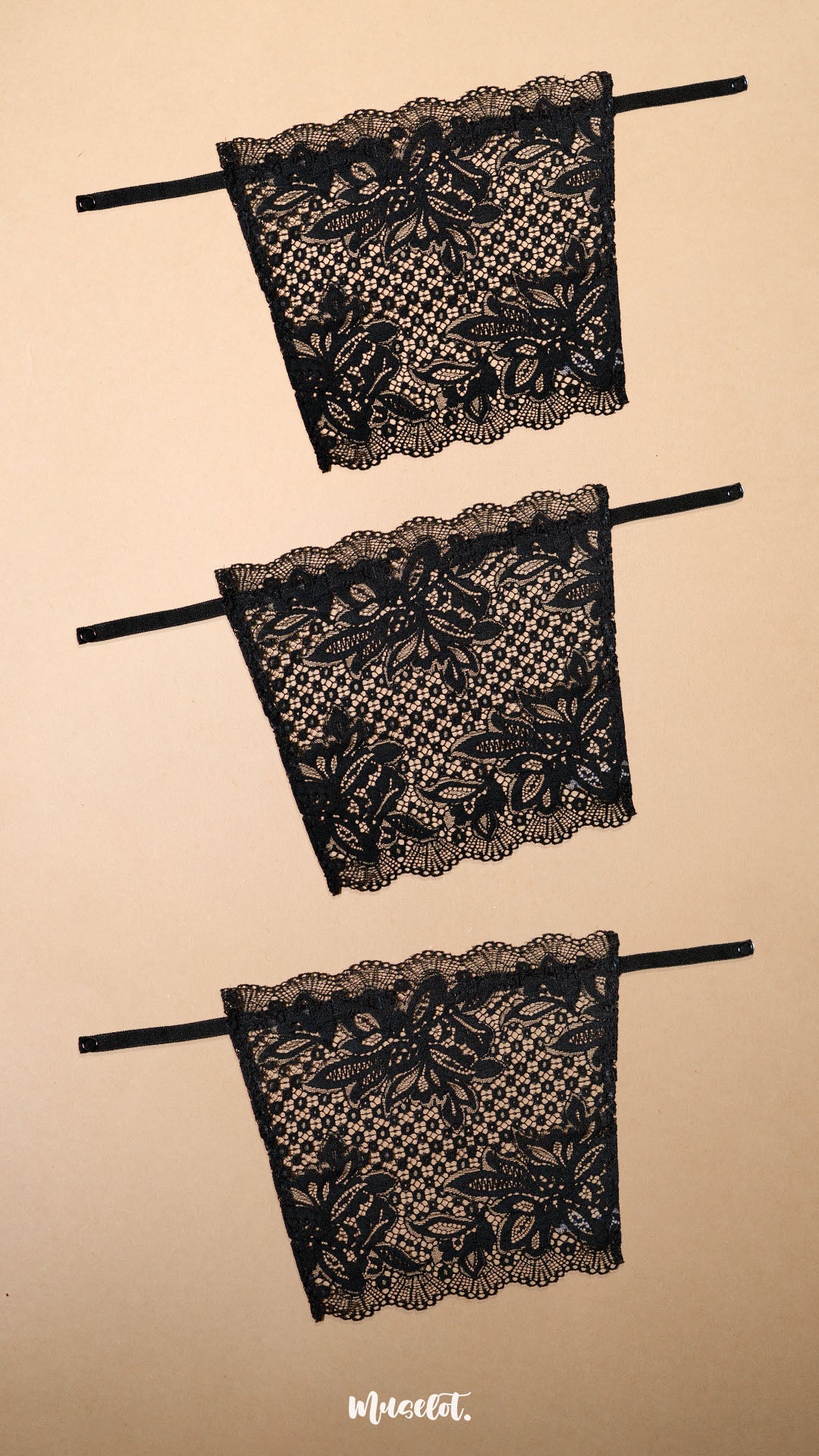 Three black lace clip-on neckline covers displayed on a beige background, featuring intricate floral lace patterns, adjustable straps and elegant scalloped edges. Designed for deep neck tops, dresses and blouses, these lightweight mock camisole inserts provide customizable neckline coverage while adding a sophisticated layered look with comfort and versatility – Muselot