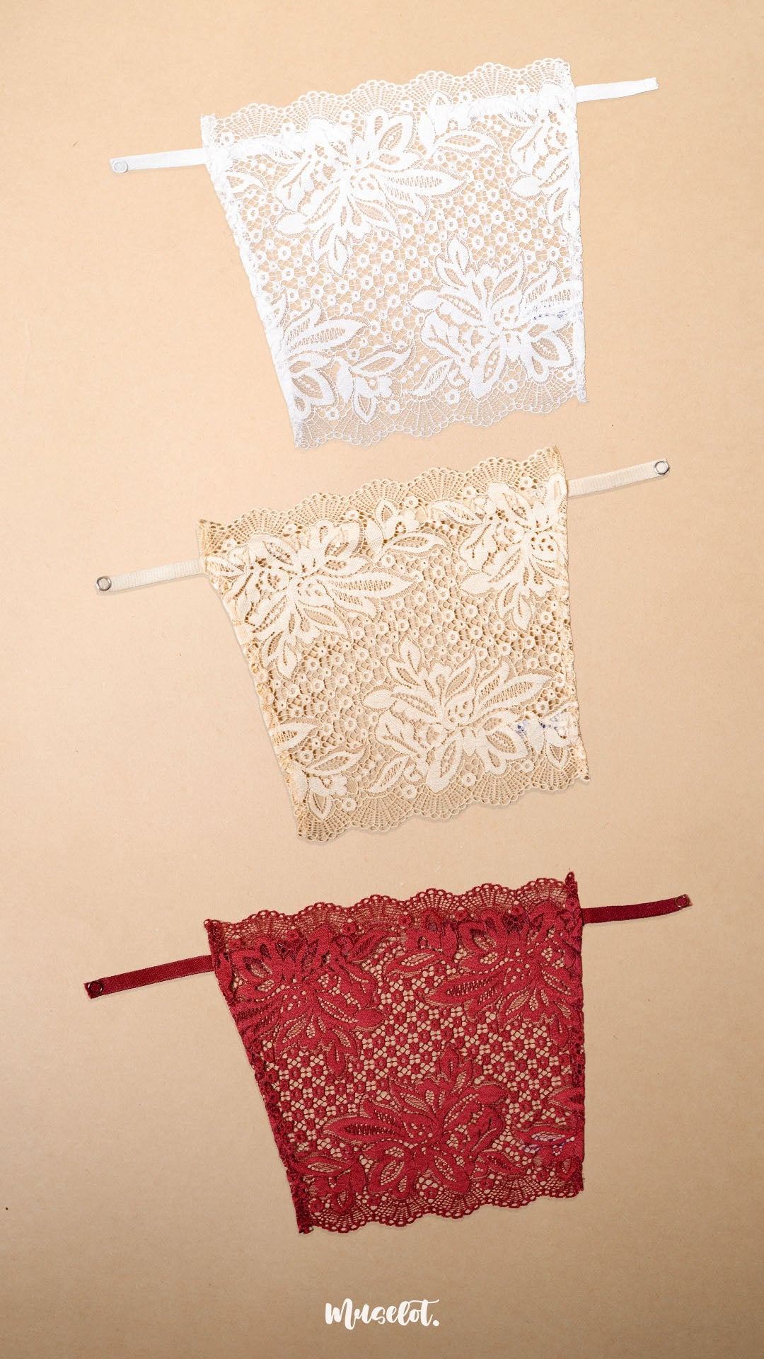 A set of clip-on lace camisoles for women displayed on a neutral beige background, featuring white, beige and maroon deep neck cover-up inserts with delicate floral lace detailing and adjustable straps for customizable neckline coverage — Muselot