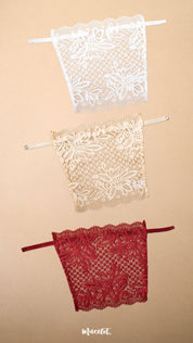 A set of clip-on lace camisoles for women displayed on a neutral beige background, featuring white, beige and maroon deep neck cover-up inserts with delicate floral lace detailing and adjustable straps for customizable neckline coverage — Muselot