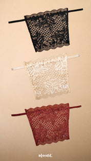 Three lace clip-on neckline covers in black, beige and burgundy displayed on a beige background, featuring rich floral lace patterns, adjustable straps and elegant neckline coverage. Perfect for deep neck tops, dresses and blouses, these breathable mock camisole inserts add a sophisticated layered look while providing comfortable coverage without adding bulk – Muselot