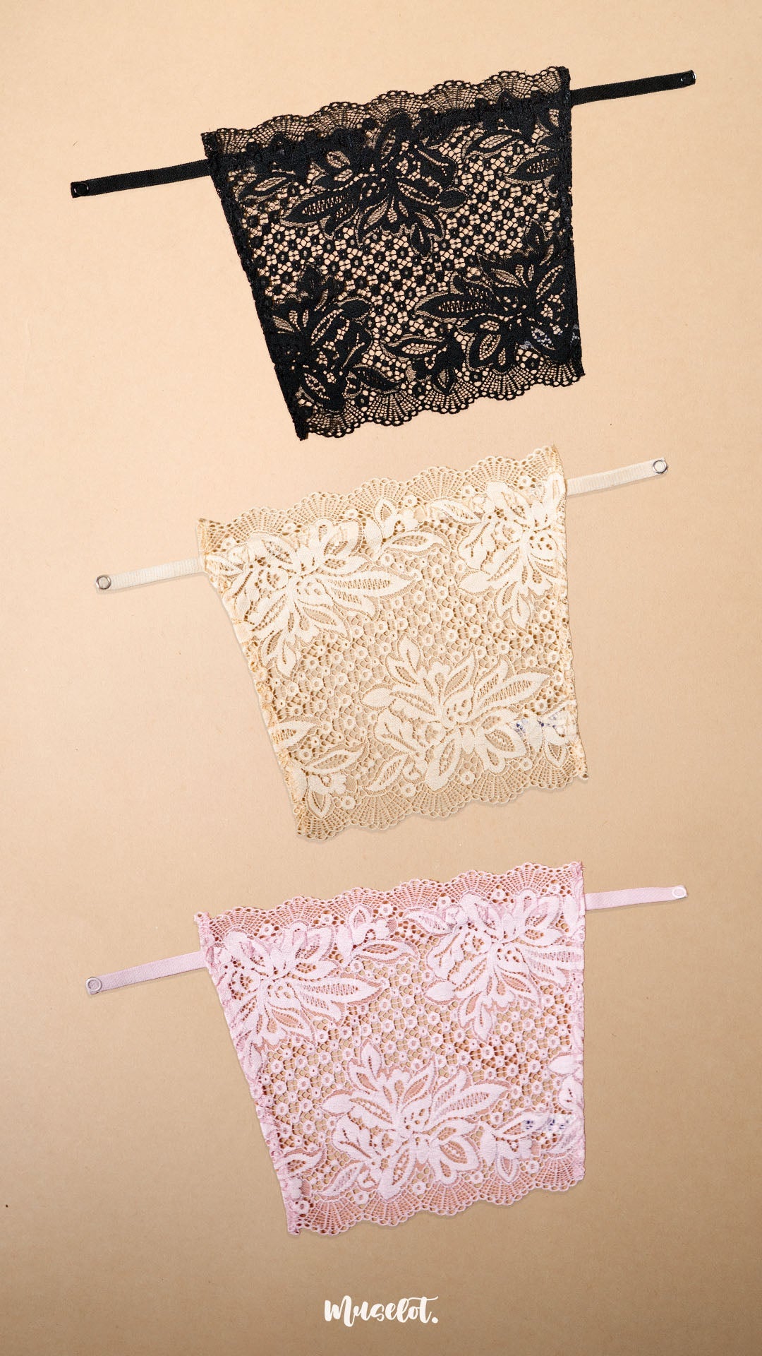 Three lace clip-on neckline covers in black, beige and light pink displayed on a beige background, featuring delicate floral lace detailing and adjustable straps. Designed to provide elegant coverage for deep neck tops, dresses and blouses, these lightweight mock camisole inserts add a feminine layered look while helping customize neckline coverage with comfort and style – Muselot
