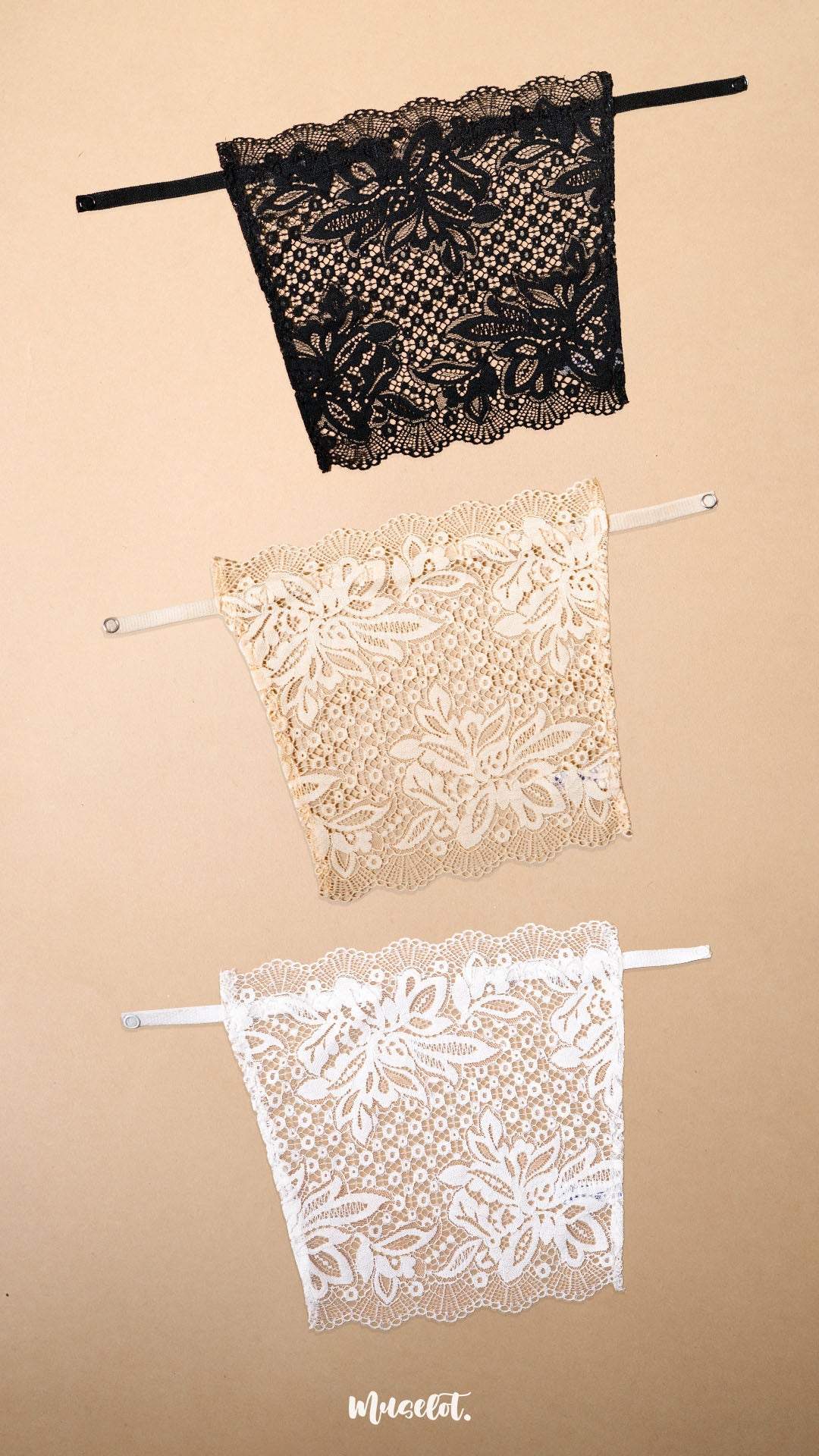 Three lace clip-on neckline covers in black, beige and white displayed on a beige background, featuring elegant floral lace patterns and adjustable straps. These deep neck cover-ups offer stylish neckline coverage for low-cut tops, dresses and blouses while adding a fashionable layered look without the bulk of a full camisole – Muselot