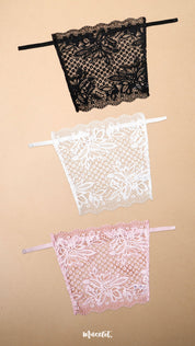 A pack of three clip-on neckline covers in black, white and baby pink is displayed on a beige background. Crafted with premium floral lace and adjustable straps, these deep neck cover-ups add elegant neckline coverage to dresses, tops, kurtis and blouses. The lightweight lace design blends seamlessly with different necklines, offering a stylish modesty panel, layering accessory and feminine fashion accent without the need for a full camisole – Muselot