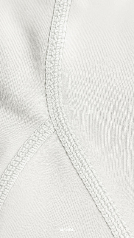 A close-up of double-stitched white opaque tights showing reinforced seams, durable finish, and premium quality craftsmanship - Muselot