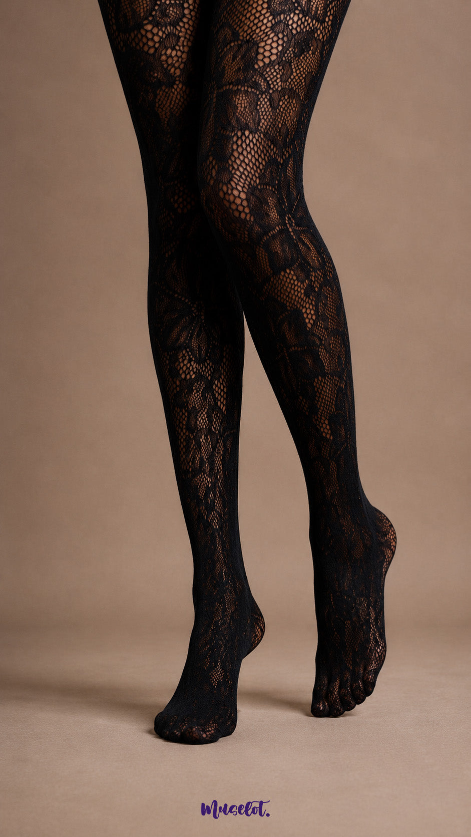 Close-up of legs and feet in black patterned lace pantyhose featuring oversized floral motifs, sheer mesh areas and covered toes - Muselot