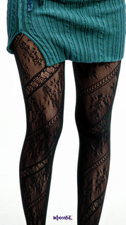 A model wearing black patterned stockings with diagonal lace design on a white background, stretchable fishnet tights - Muselot