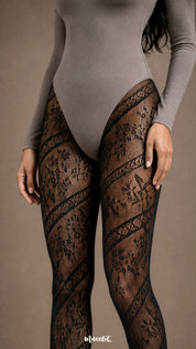 Close-up of black designer lace stockings featuring diagonal floral lace bands and semi-sheer mesh detailing across the thighs - Muselot