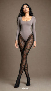Full-length front view of a woman wearing black patterned lace stockings with diagonal floral motifs, semi-sheer mesh and closed-toe coverage - Muselot