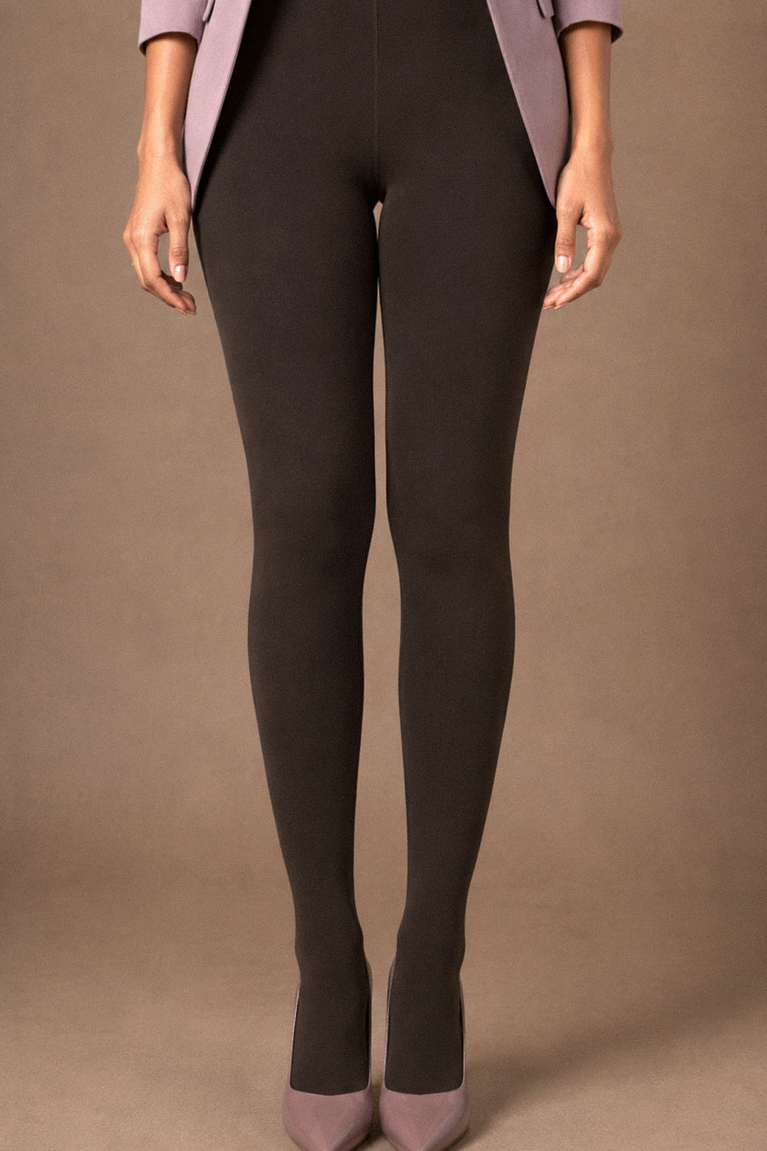 Front view of dark brown fur lined winter tights showing a smooth high-waist fit and fully covered feet worn with heels.