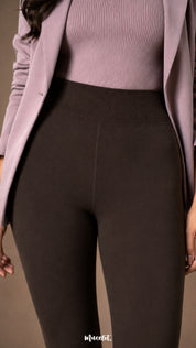 Close-up of dark brown fur lined stockings showing the wide ribbed waistband, high-rise fit and smooth winter fabric.