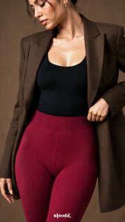 Close-up of maroon fur lined stockings showing the wide high waistband, smooth opaque surface and fitted winter construction - Muselot