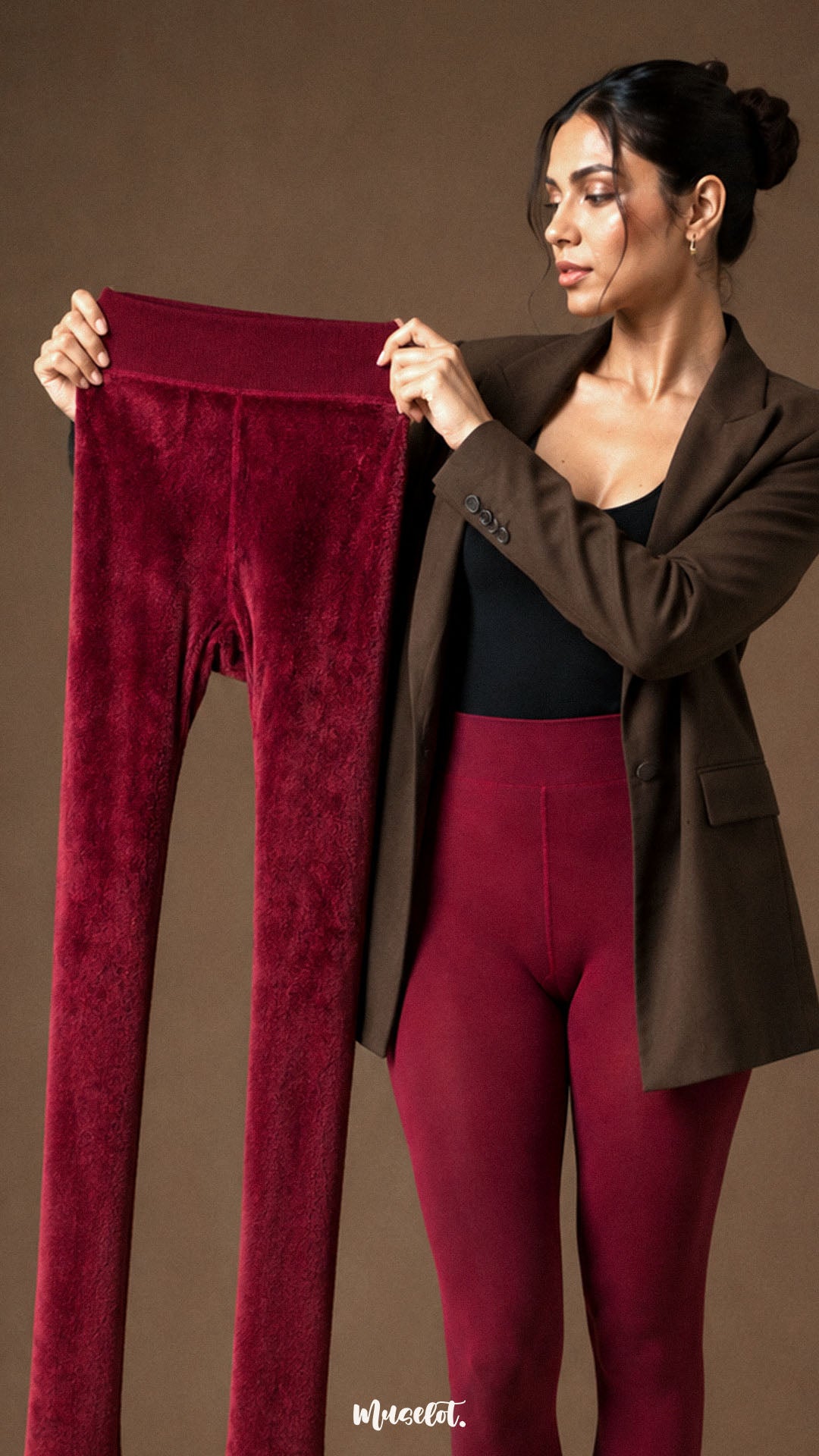 A woman holding maroon closed-foot winter stockings to display the dense plush fur lining and warm thermal construction - Muselot