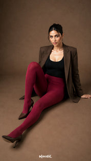 A woman wearing maroon fur lined winter tights with closed feet, smooth full-leg coverage and high waist styling - Muselot