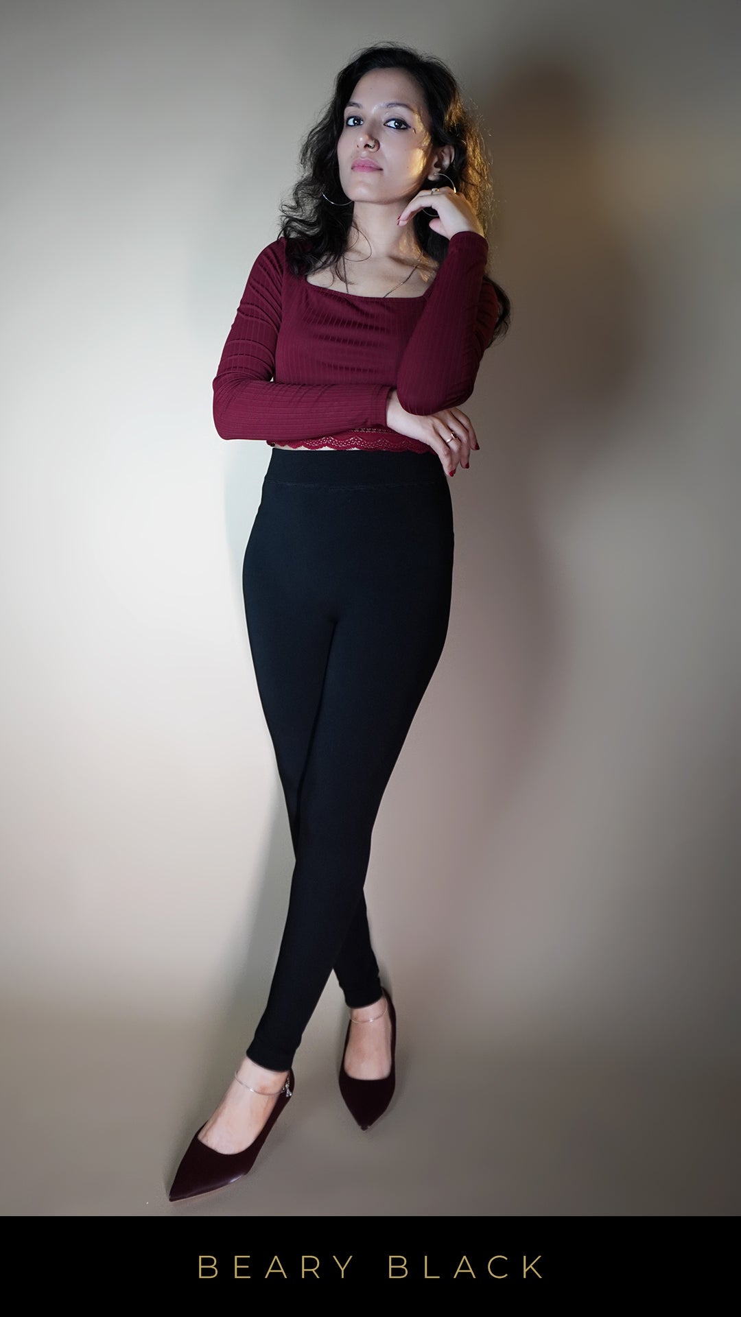 A model, wearing fur-lined open-feet warm tights, is showcasing the plush, insulating lining that provides extra warmth and comfort. The open-foot design adds versatility, while the cozy fur and deep tone make these tights both stylish and functional for colder days. -Muselot