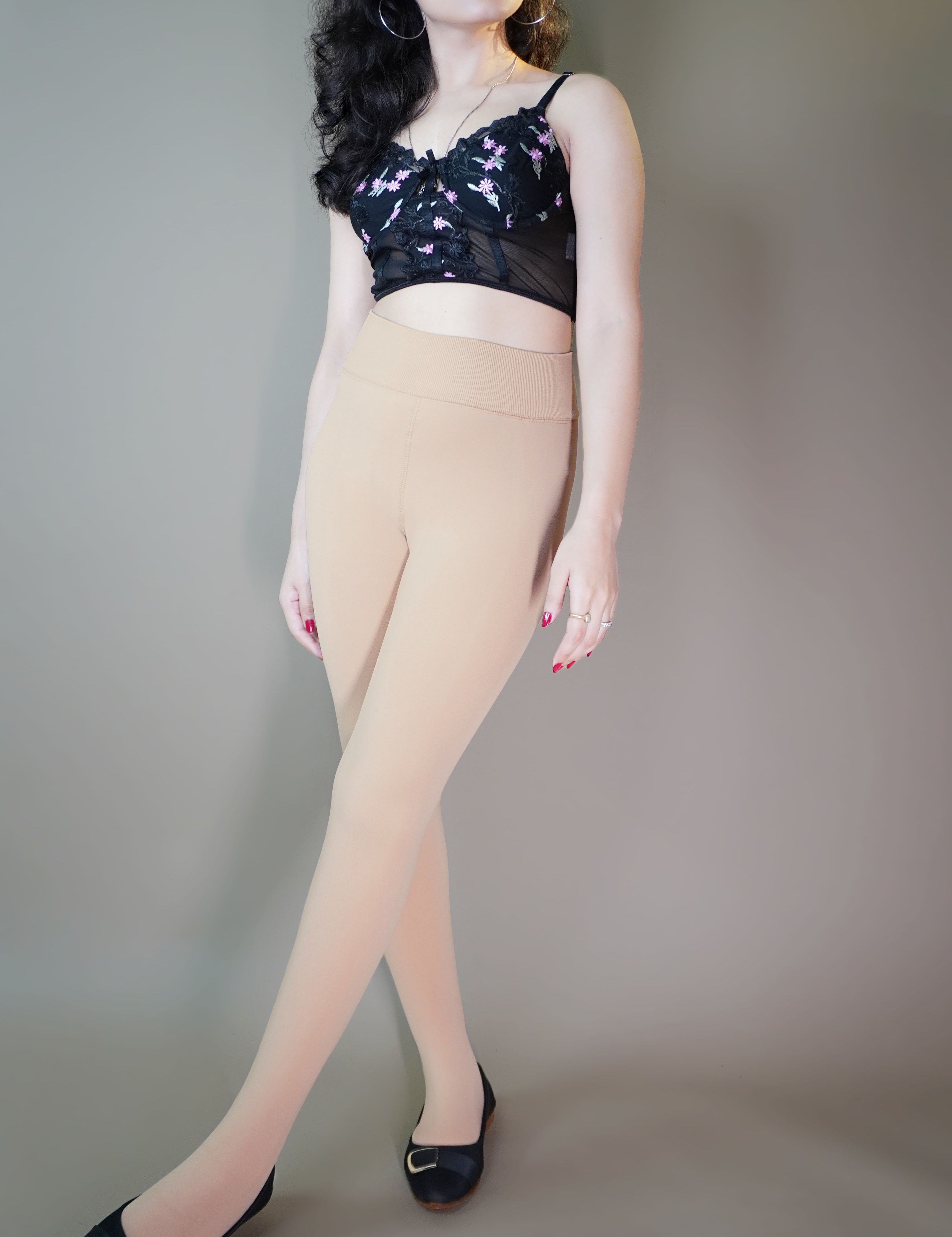 A model, wearing fur-lined skin tights, showcasing the soft, plush lining that provides added warmth and comfort. The skin color highlighting a seamless, natural look, making these tights both stylish and cozy for colder days. -Muselot