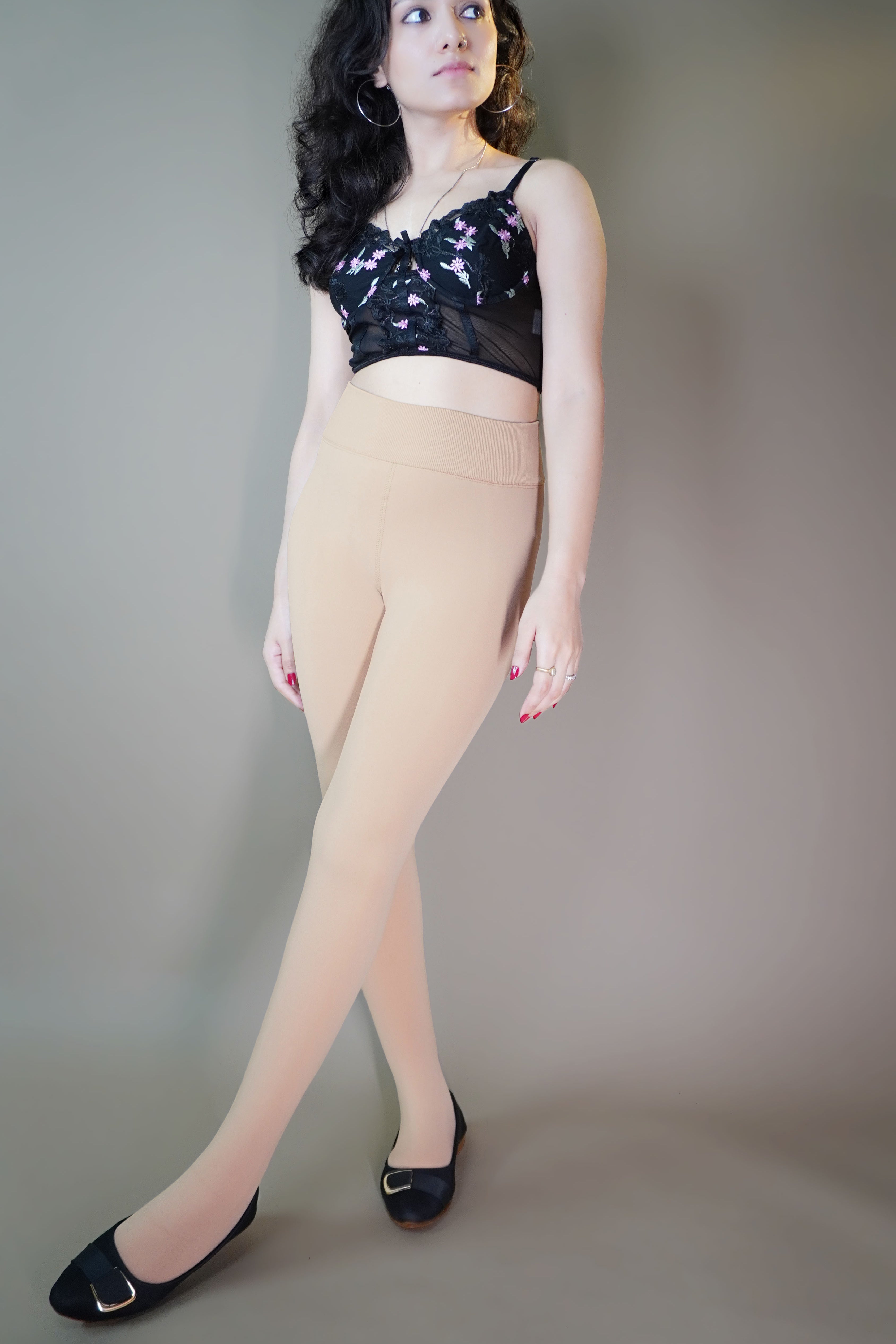 A model, wearing fur-lined skin tights, showcasing the soft, plush lining that provides added warmth and comfort. The skin color highlighting a seamless, natural look, making these tights both stylish and cozy for colder days. -Muselot
