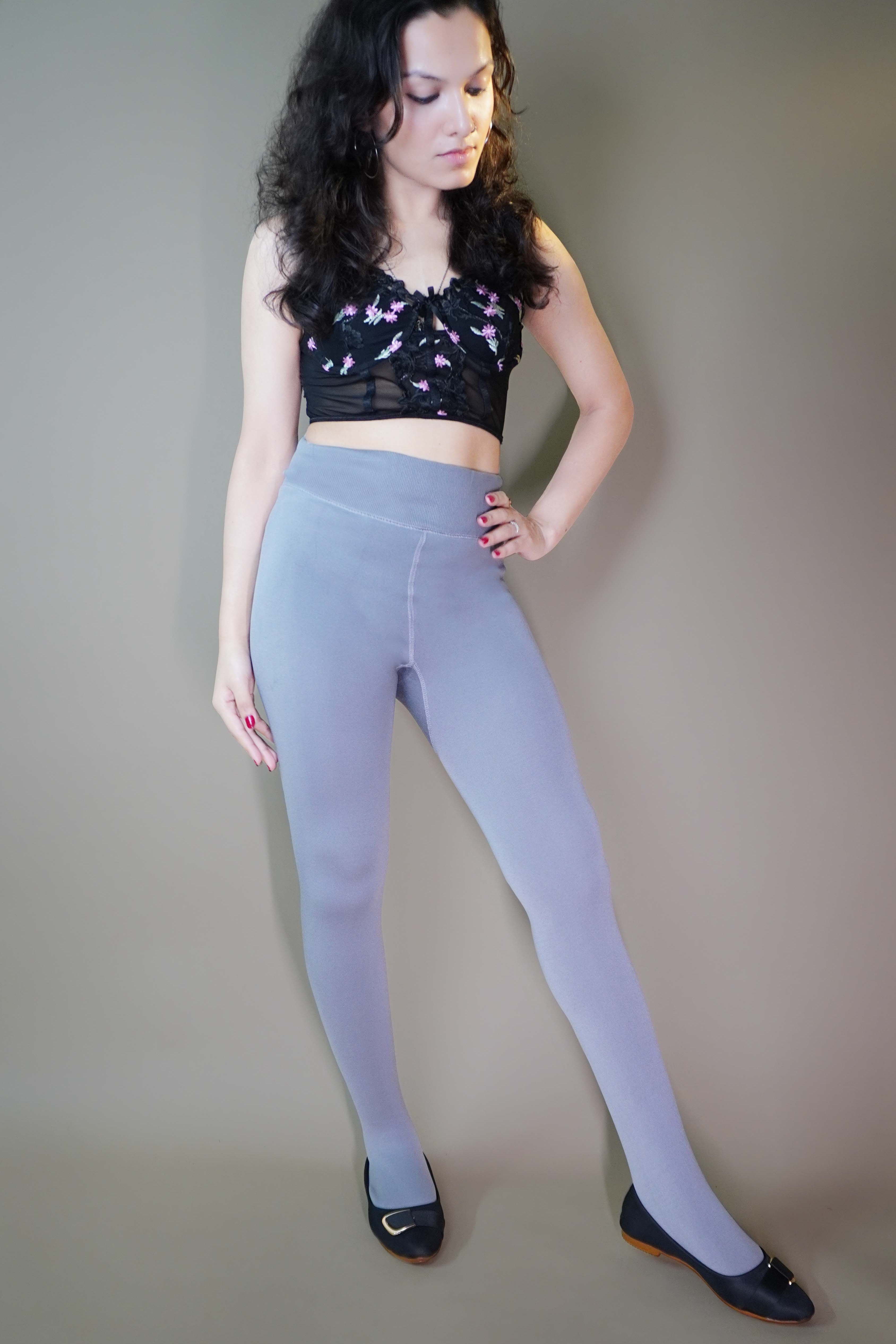 A model, wearing furry warm plush grey tights, showcasing their soft, luxurious texture that offers both warmth and comfort. The grey color highlights a cozy, stylish design, making these tights a perfect choice for colder days. -Muselot