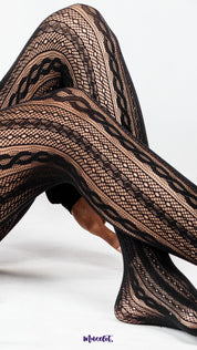 A close up of crossed legs wearing black patterned lace stockings on white background, highlighting intricate fishnet texture and net design for statement styling – Muselot