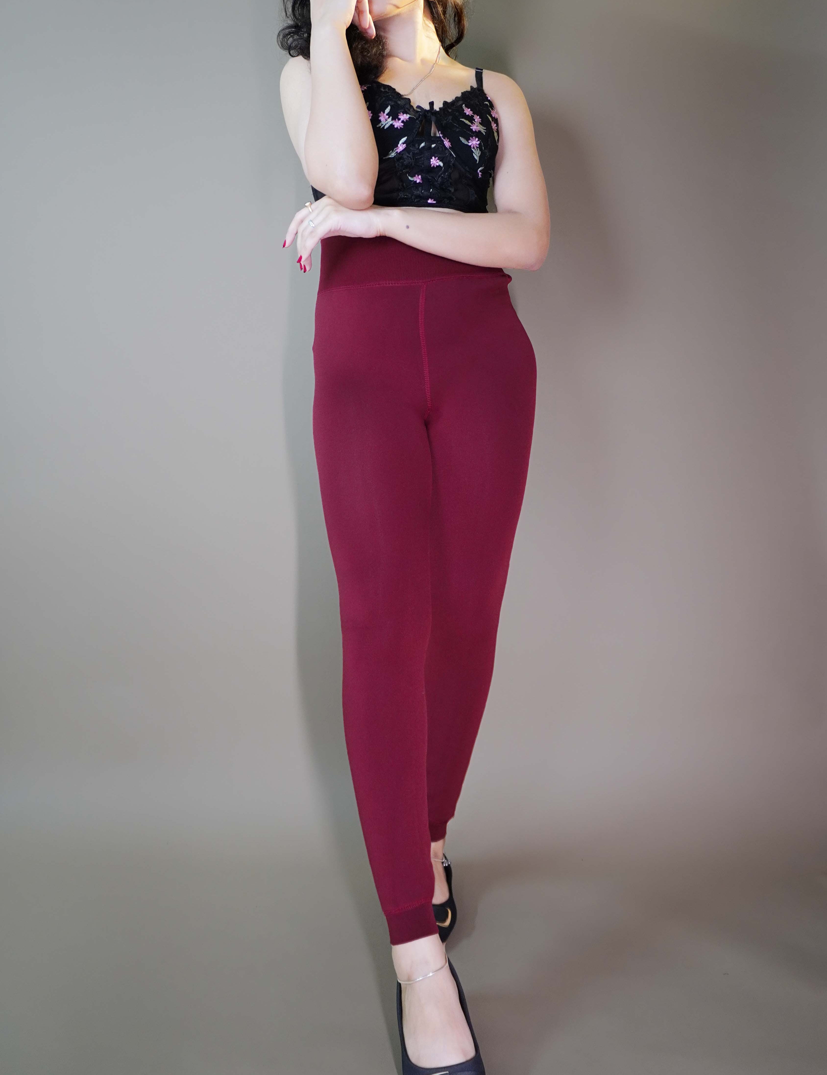A model, wearing maroon thermal stockings, showcasing their soft, thick fabric designed to keep warmth in. The rich maroon tone contrasts beautifully with the cozy texture, emphasizing both style and comfort for chilly weather. -Muselot