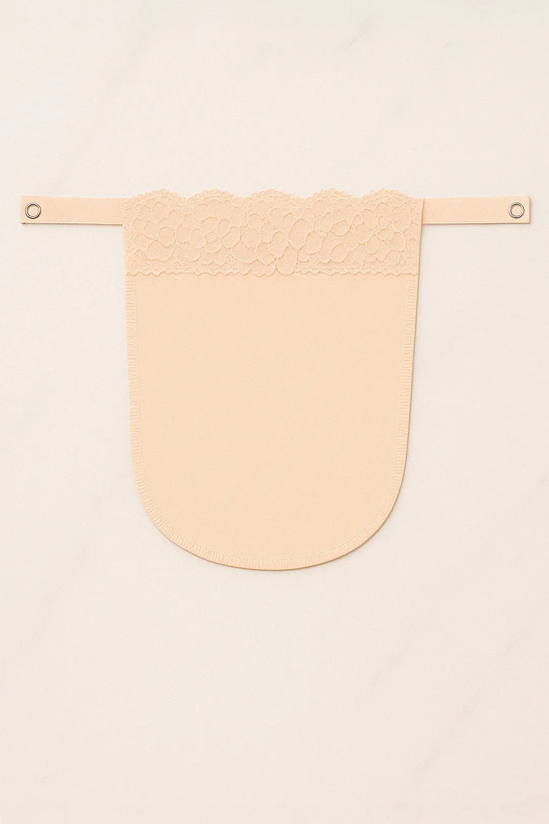 Beige solid mocker modesty panel in flatlay view, displaying intricate lacework and secure clip design for graceful deep-neck coverage — Muselot.