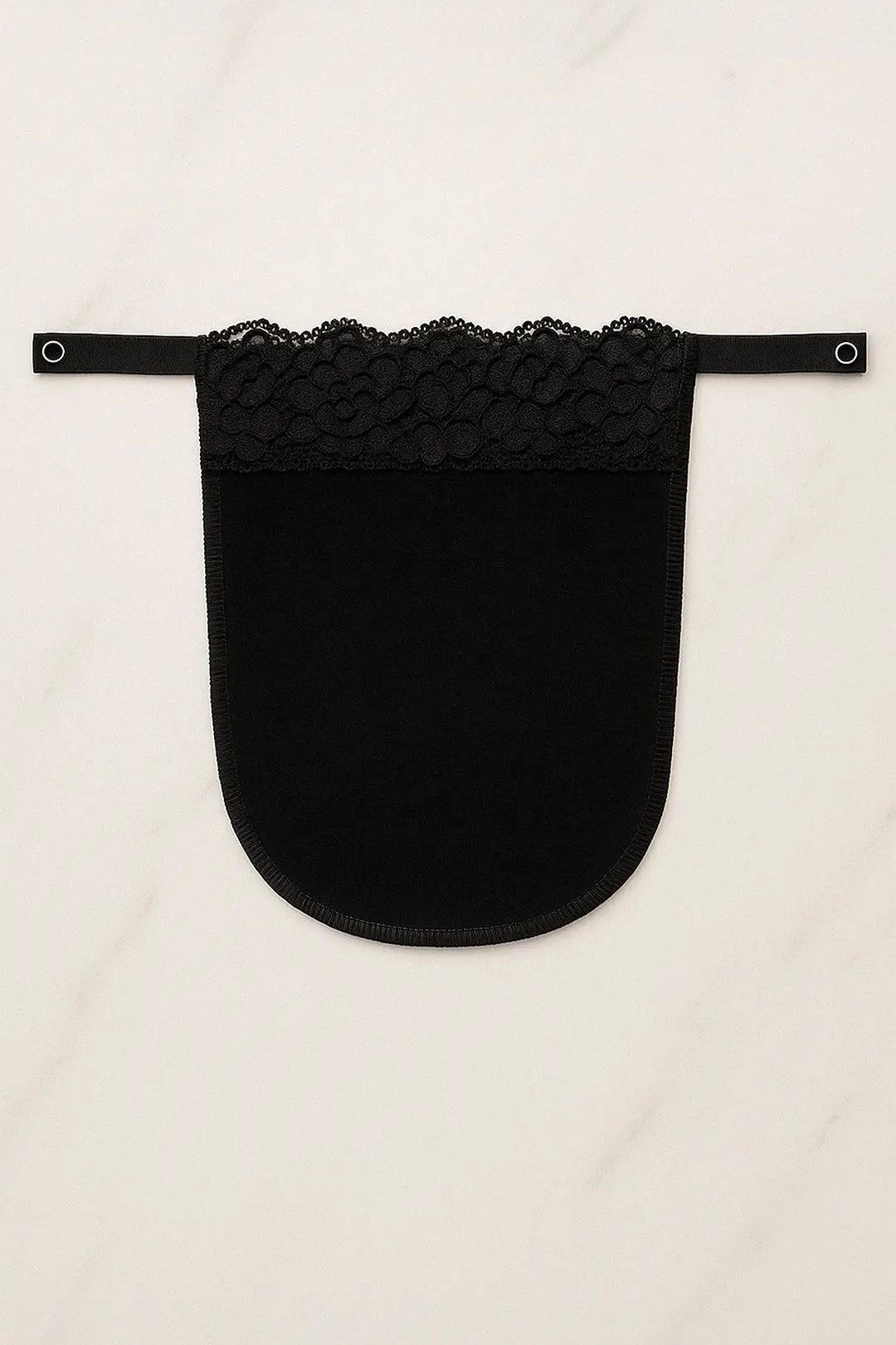 Black lace mocker modesty panel in flatlay view, showing intricate lace pattern and secure clip design for deep-neck coverage — Muselot.