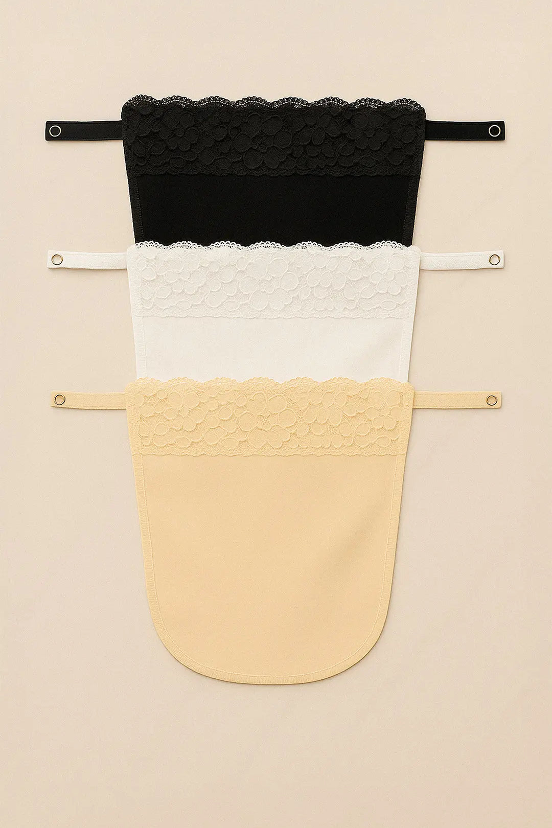 Flatlay of lace mockers in black, white, and beige, showcasing intricate lacework and versatile deep-neck coverage options — Muselot.