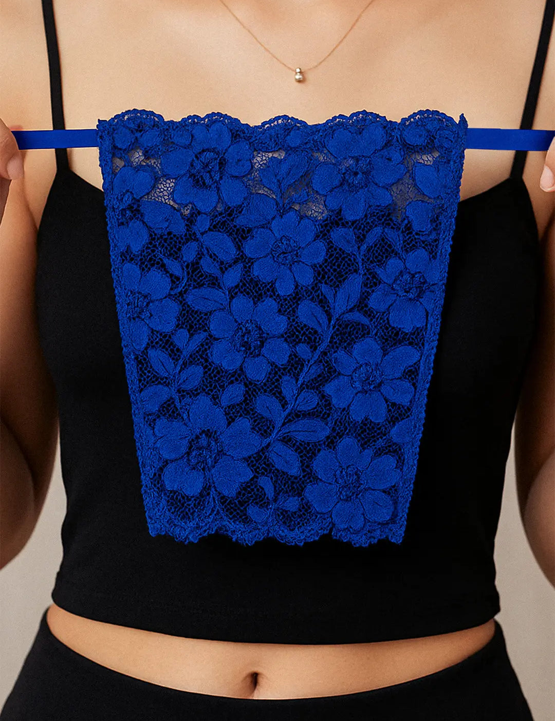 Close-up of model holding Lacy Royal Blue Mockers, showcasing the bold lace texture and rich color that elevates deep-neck outfits – Muselot.