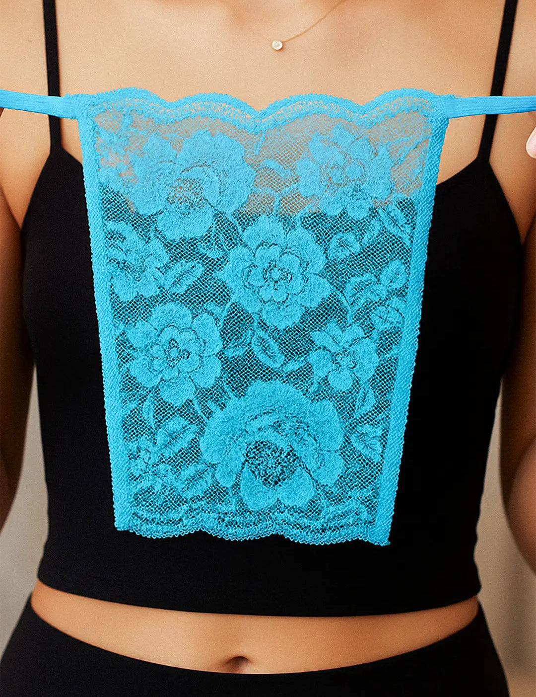 Close-up of model holding Lacy Turquoise Blue Mockers, showcasing the intricate lacework and vibrant hue that adds a refreshing touch to deep-neck outfits – Muselot.