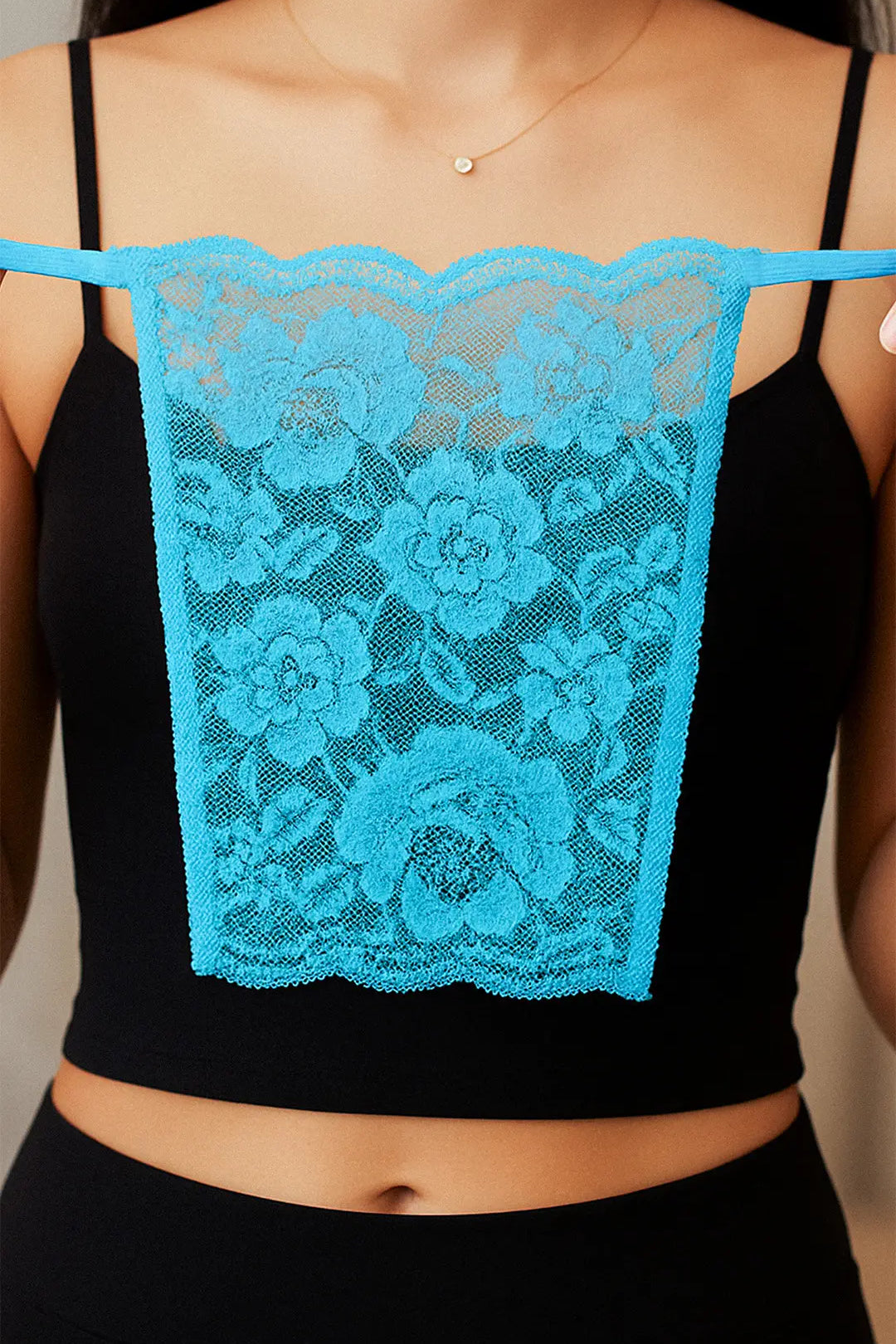 Close-up of model holding Lacy Turquoise Blue Mockers, showcasing the intricate lacework and vibrant hue that adds a refreshing touch to deep-neck outfits – Muselot.