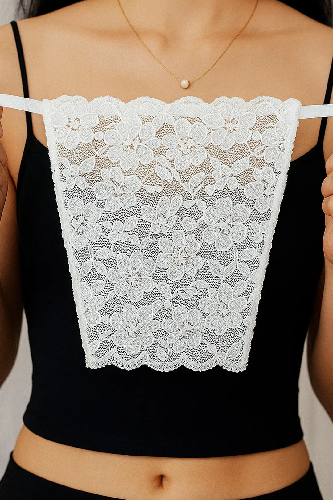 Close-up of model holding Lacy White Mockers, highlighting the delicate lace detail and timeless design that adds elegance to deep-neck outfits – Muselot.