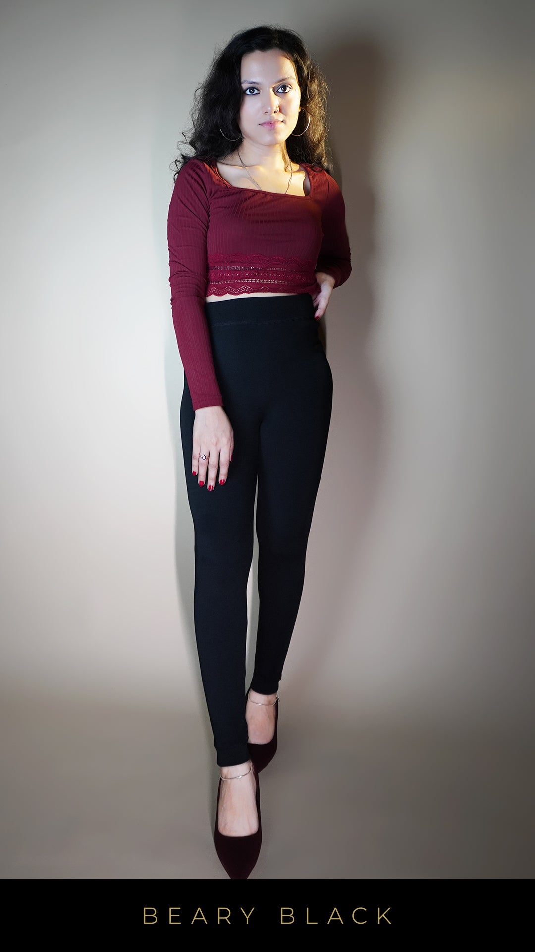 A beautiful model wearing open-feet black warm tights, is highlighting their snug, body-hugging fit with an open-foot design that adds a stylish, practical twist-Muselot