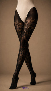 A zoom in view of crossed legs wearing Royal Black patterned stockings with intricate lace bands and delicate mesh detailing - Muselot