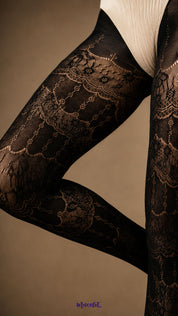 Close-up of black designer lace stockings showing the intricate ornate lace pattern, scalloped motifs and semi-sheer mesh texture across the legs - Muselot