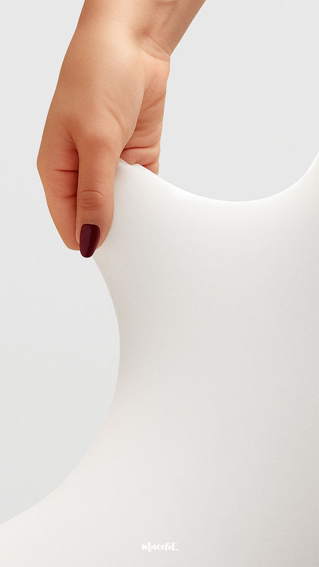A hand stretching semi-opaque white tights to showcase fabric elasticity, tear-proof strength, and high-quality stretchability - Muselot