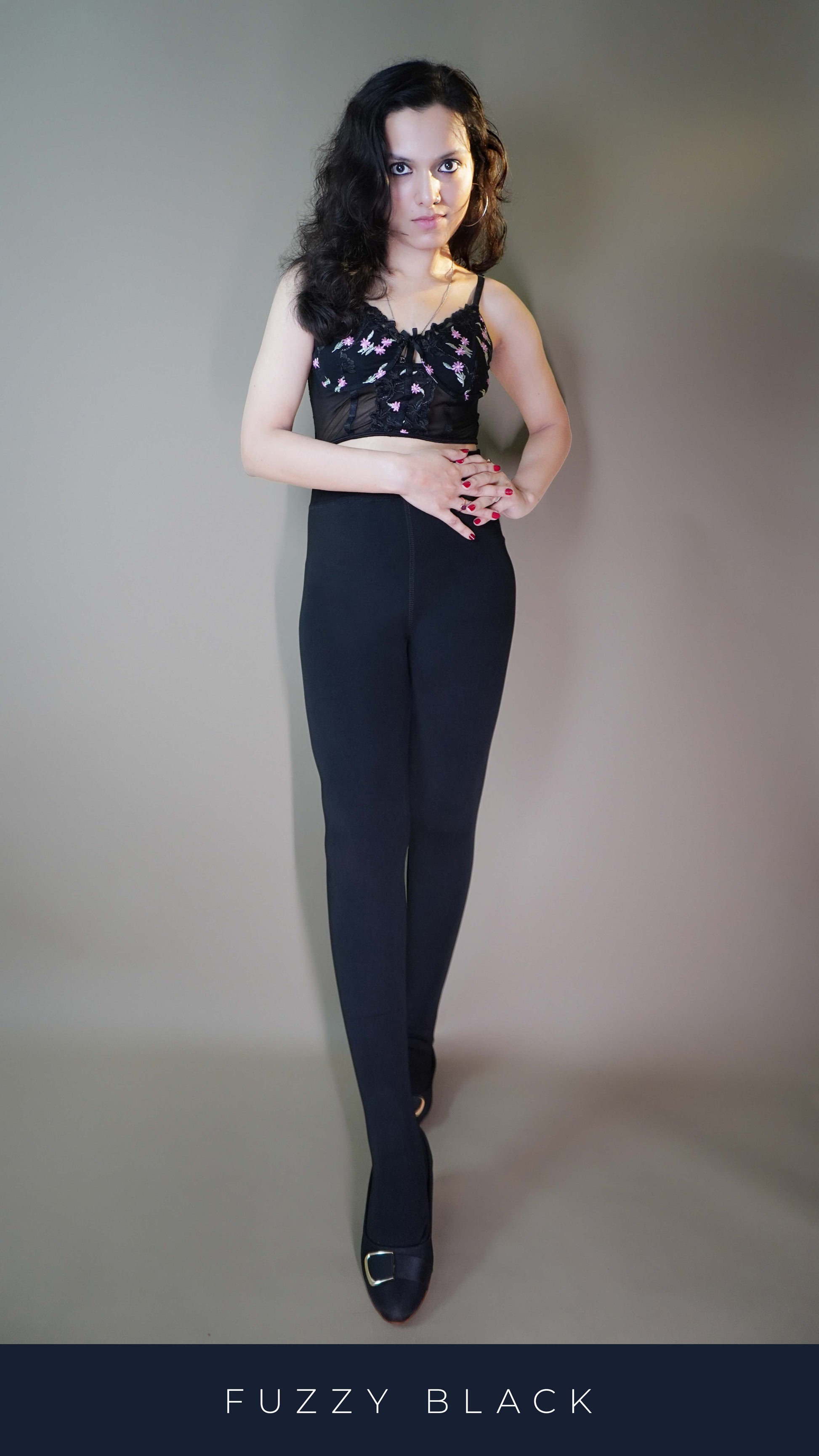 A model, wearing stylish black furry tights, paired with a trendy top, showcasing their bold, textured design that adds a touch of elegance and warmth. These tights highlight a modern, fashionable look while offering exceptional comfort, perfect for both casual and chic settings. -Muselot