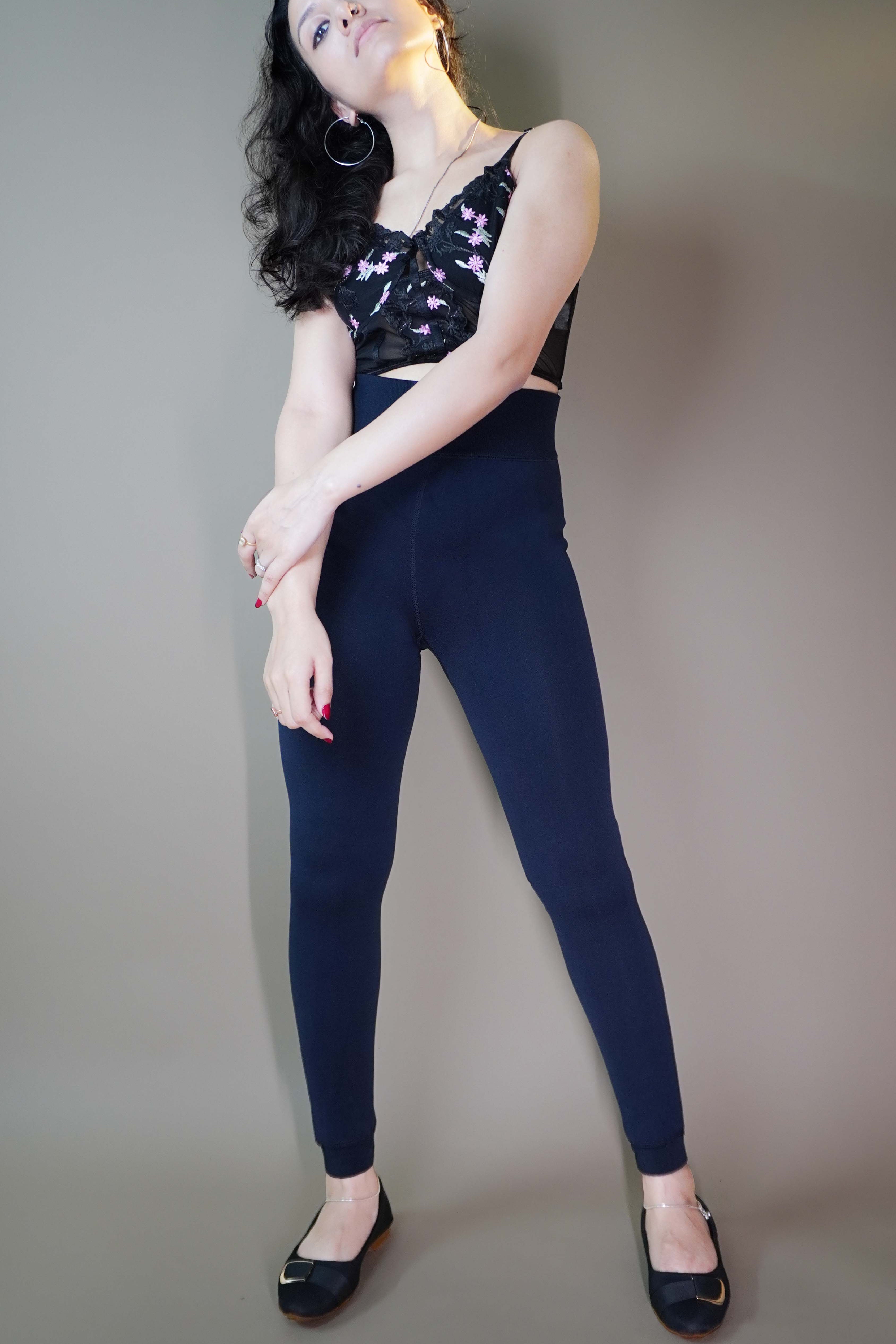 A model wearing stylish dusk blue furry tights paired with a black top showcasing the luxurious plush texture and trendy appeal. Perfect for adding warmth and elegance to any outfit. -Muselot






