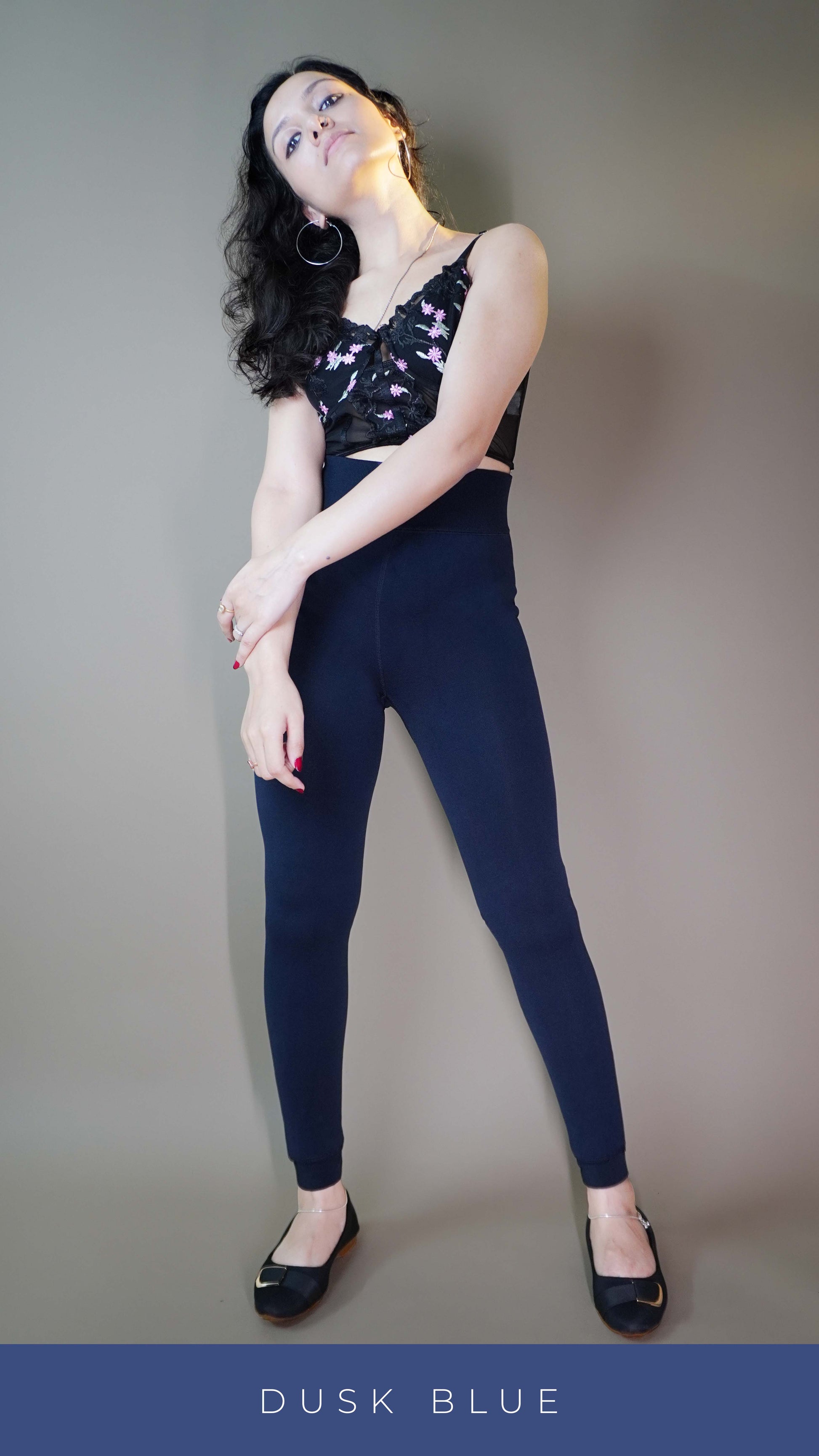 A model wearing stylish dusk blue furry tights paired with a black top showcasing the luxurious plush texture and trendy appeal. Perfect for adding warmth and elegance to any outfit. -Muselot






